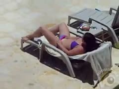 A brunette wife in a bikini was caught masturbating by the pool.